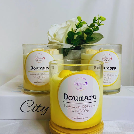 Handmade organic citrus and sage scented candle in a simple, reusable glass jar, evoking a fresh and invigorating ambiance.